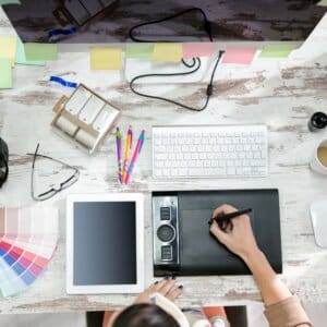 woman designer working on the pen table in office top view